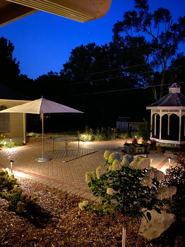Outdoor lighting illuminating patio and hardscape features